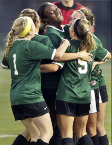 Rattler teammates congratulate Tia Pearcy on her goal which proved to be the winning score as the Reagan girls beat Smithson Valley 1-0 in third round 6A soccer playoffs at the UTSA Park West Complex on April 7, 2015.